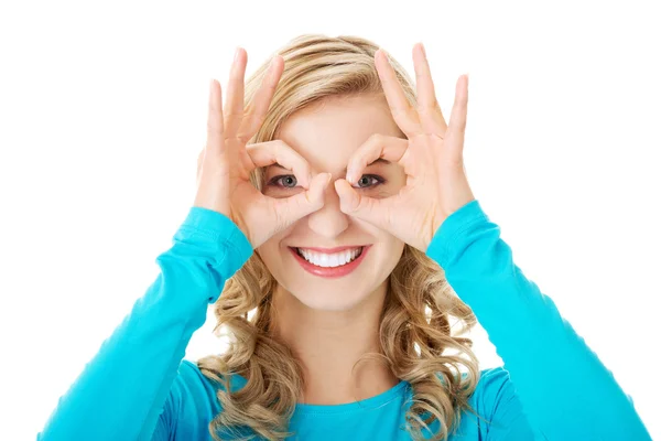 Woman showing ok sign on eyes Stock Image