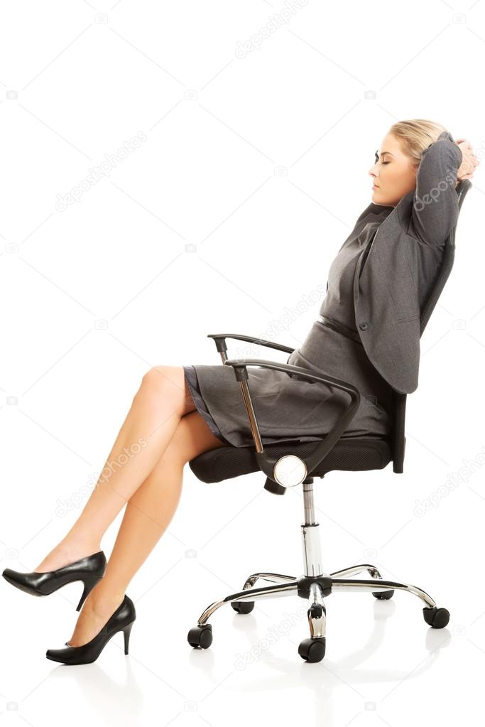 Businesswoman resting on armchair