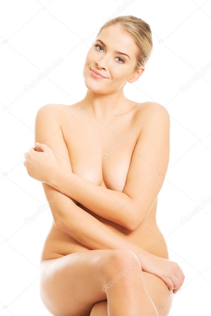 Nude woman sitting with cross legs