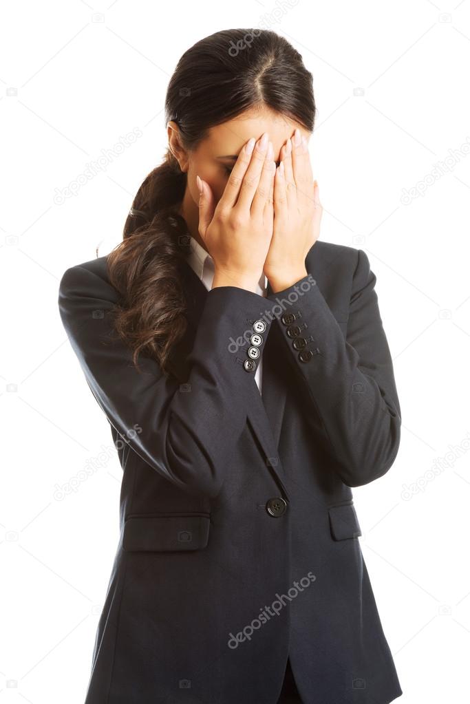 Businesswoman covering her face