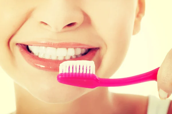 Jeune femme avec brosse à dents et pâte . — Photo