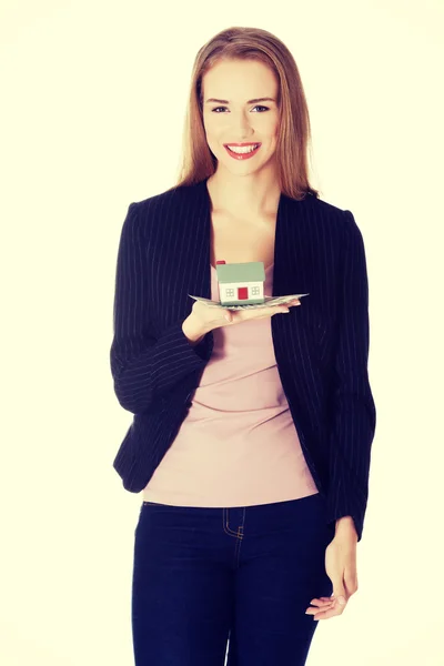 Businesswoman holding small house on palm. — Stock Photo, Image