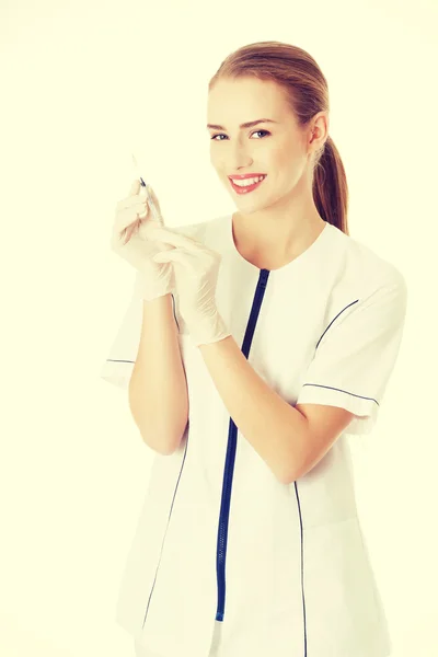 Beautiful young nurse or doctor with needle. — Stock Photo, Image