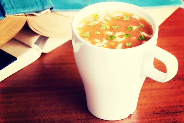 Hot vegetable soup in a cup.