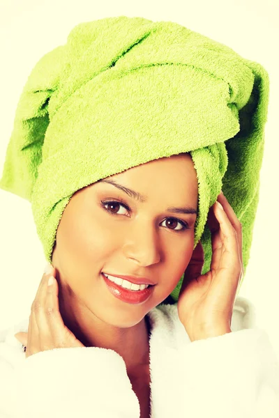 Attractive woman in bathrobe and turban on head — Stock Photo, Image