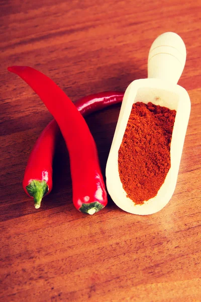 Two chili peppers with paprika spice. — Stock Photo, Image