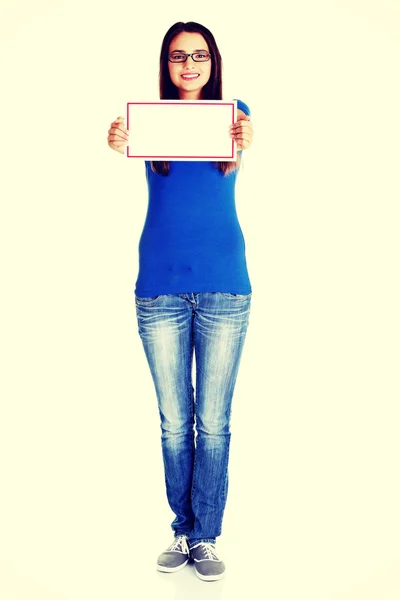 Young casual woman holding copy space. — Stock Photo, Image
