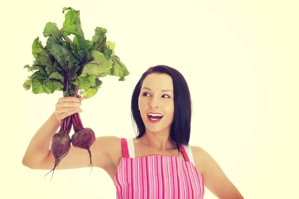 Jonge vrouw in schort en bedrijf beetroots. — Stockfoto