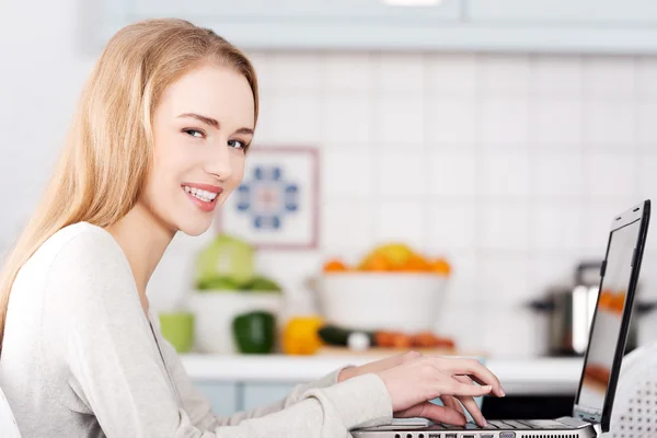 Young woman using a laptop computer at home — Stock Photo, Image