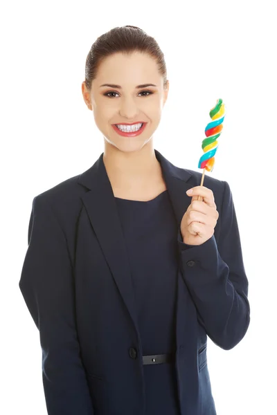 Beautiful businesswoman with lollipop — Stock Photo, Image
