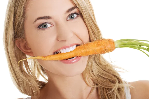 Young woman with the carrots — Stock Photo, Image