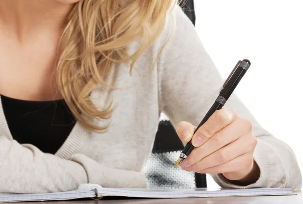 Hand writes with a pen in a notebook — Stock Photo, Image