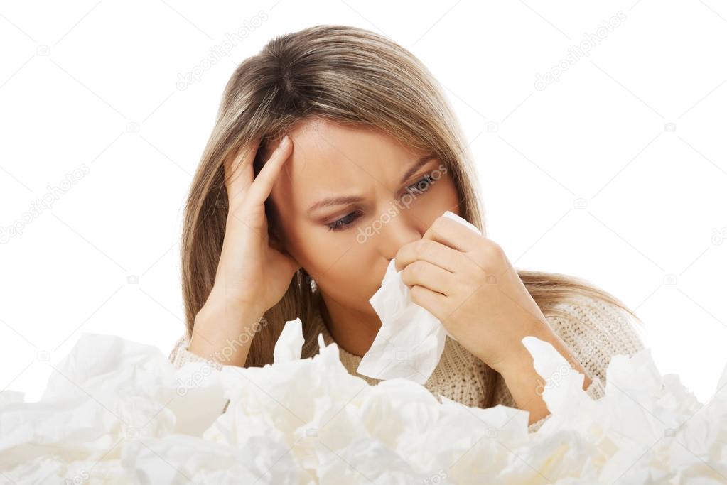 Young woman in lot of tissues around