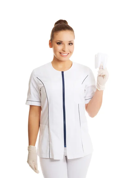 Female dentist holding a tooth model — Stock Photo, Image