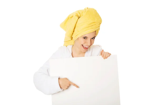 Woman in bathrobe holding empty banner — Stock Photo, Image