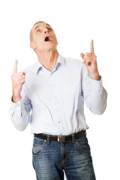 Happy handsome man pointing up — Stock Photo, Image