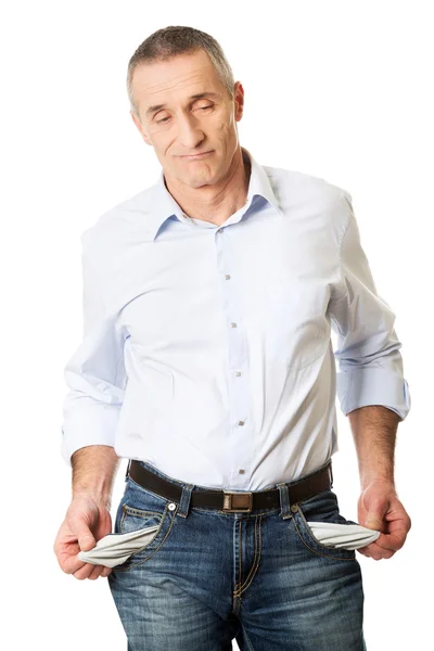 Confused man showing his empty pockets — Stock Photo, Image