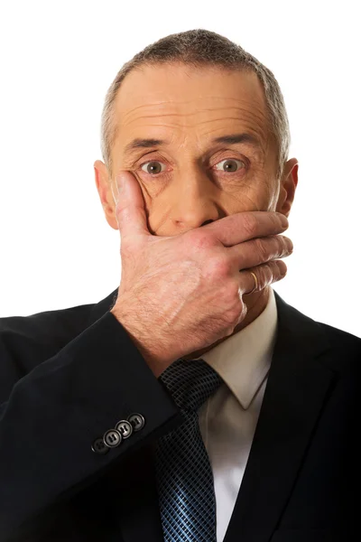 Affärsman som täcker munnen — Stockfoto