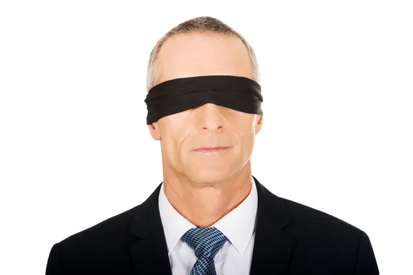 Businessman with band on eyes — Stock Photo, Image