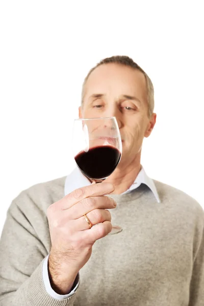 Mature man tasting red wine — Stock Photo, Image