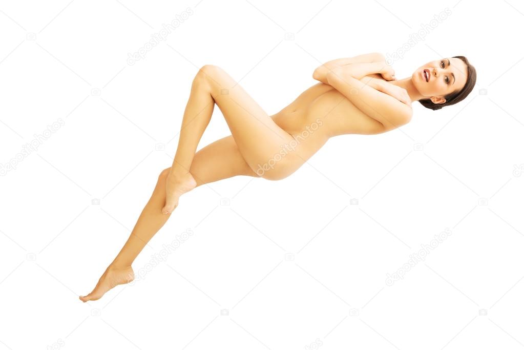 Above view nude woman lying down covering breast