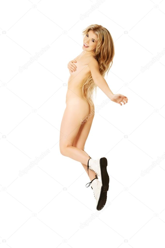 Jumping nude woman with heavy metal boots