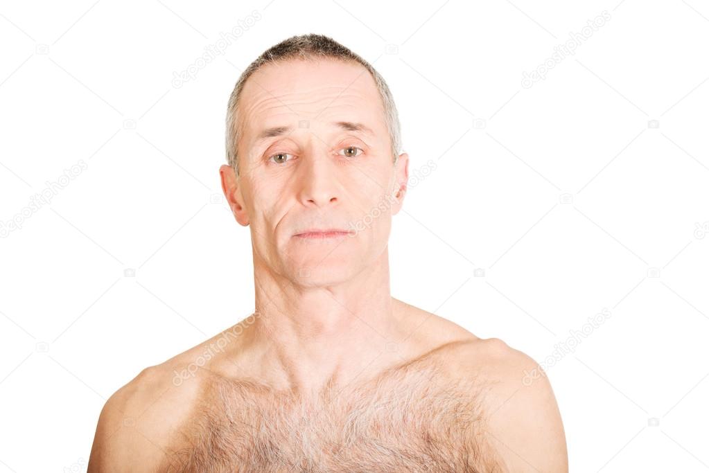 Download - Old Serious shirtless mature man looking at camera - Stock Image...