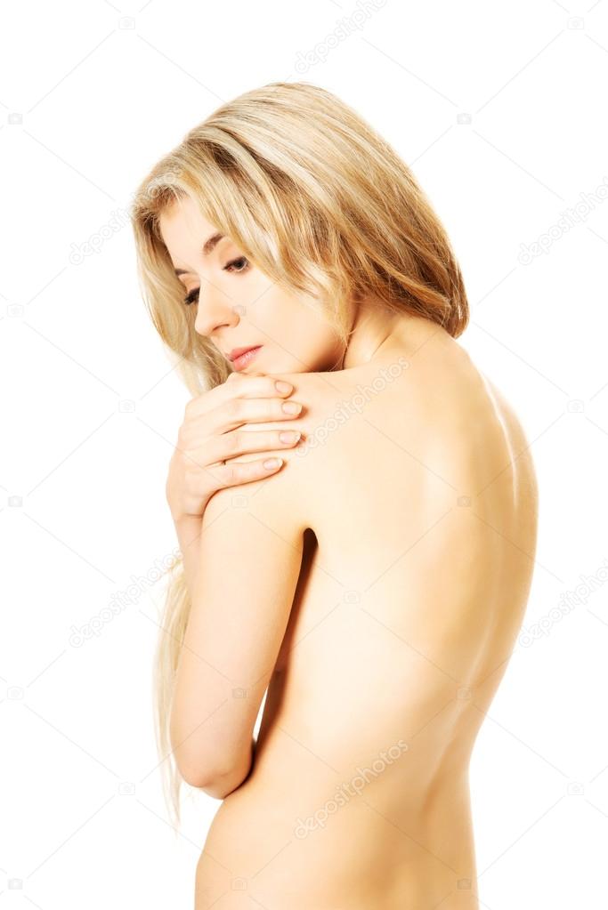 Worried naked woman with closed eyes