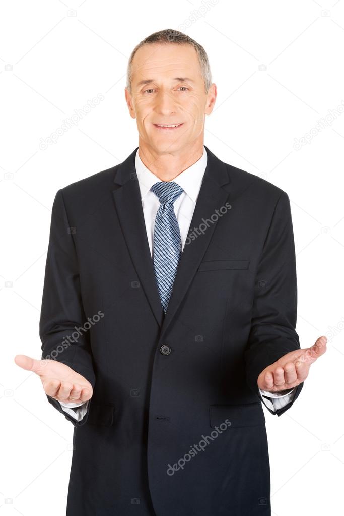 Friendly businessman with welcome gesture