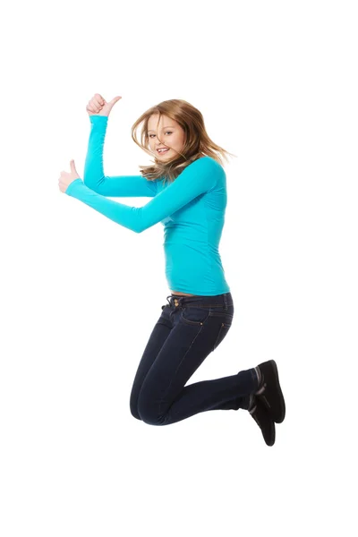 Woman jumping with thumbs up — Stock Photo, Image