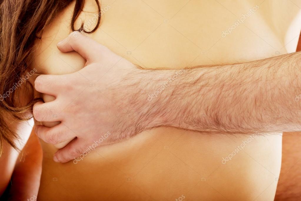 Man touching female breast