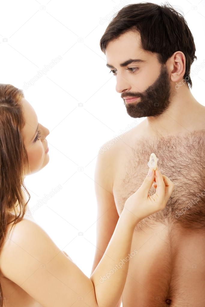 Woman giving a condom to her man.