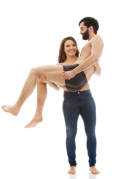 Woman carrying man on her arms. — Stock Photo, Image