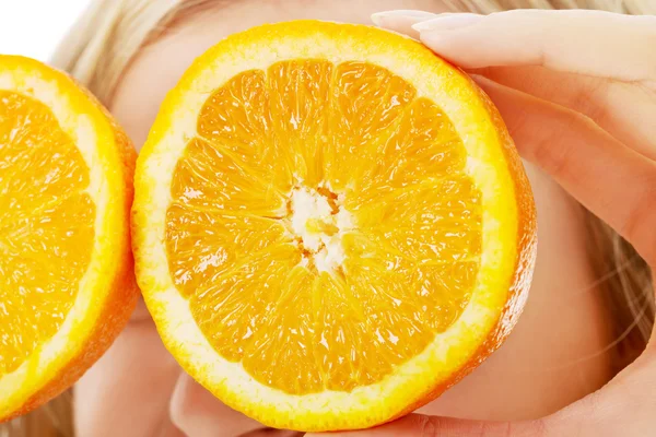 Woman holding oranges on eyes — Stock Photo, Image