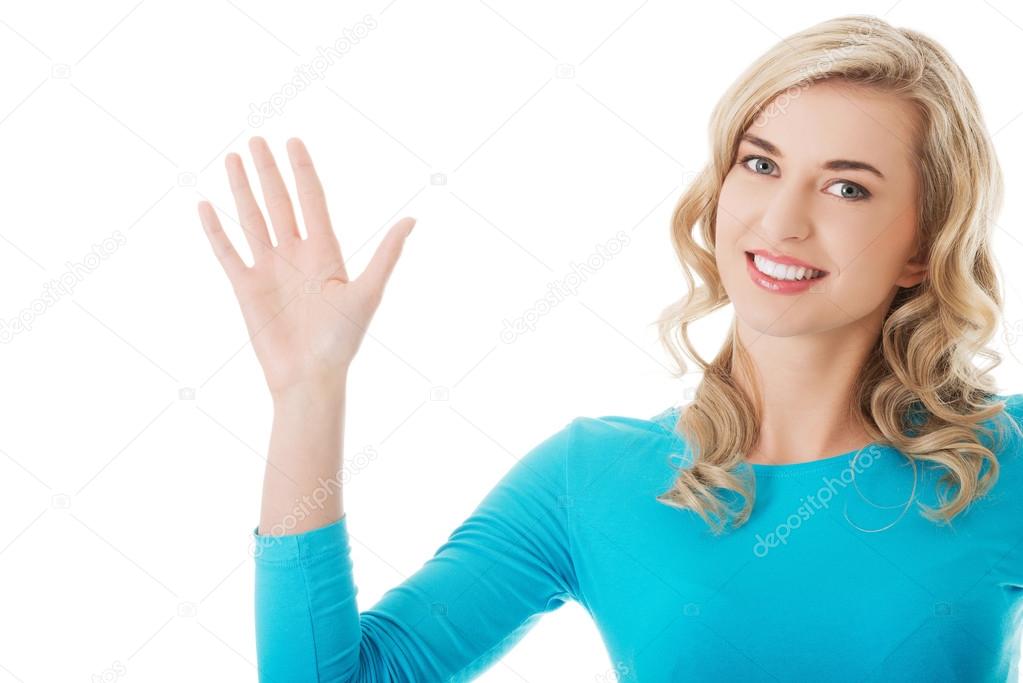 Woman waving to the camera