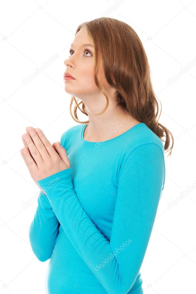 Woman praying holding clasp hands