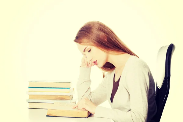 Bored casual student woman sitting by the desk — Stock Photo, Image