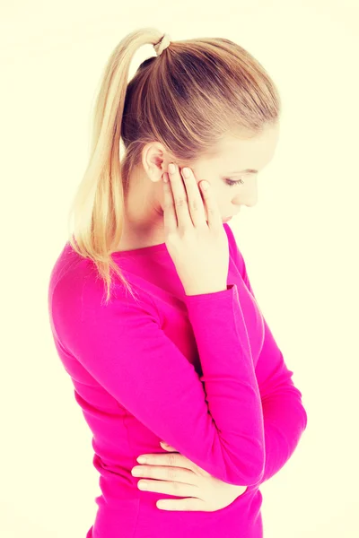 Beautiful woman is touching her temples. — Stock Photo, Image