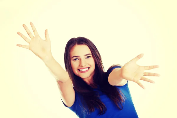 Young casual woman with palms in front. — Stock Photo, Image