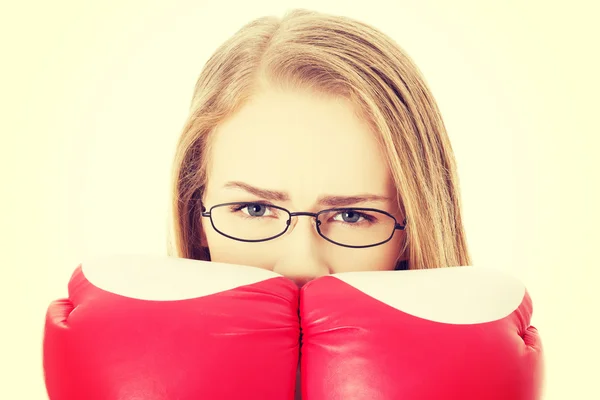 Beautiful woman behind boxing gloves. — Stock Photo, Image