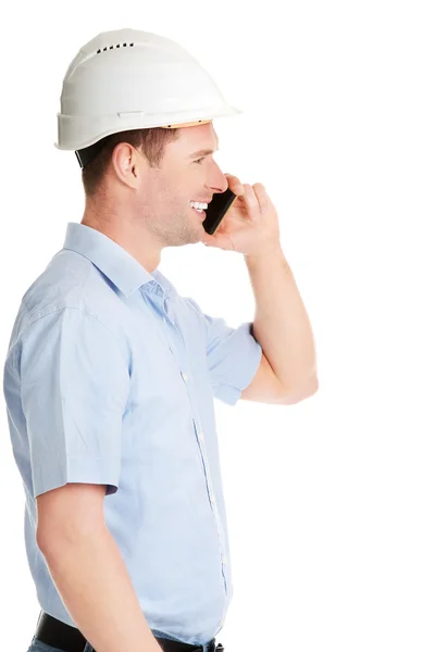 Contractor in hardhat talks on his cell phone. — Stock Photo, Image