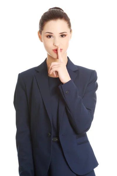 Businesswoman with finger on her lips — Stock Photo, Image