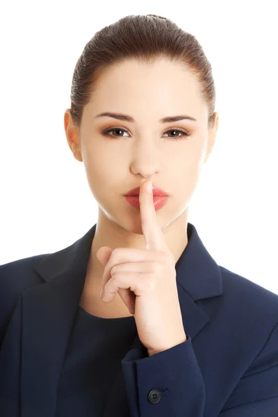 Businesswoman with finger on her lips — Stock Photo, Image