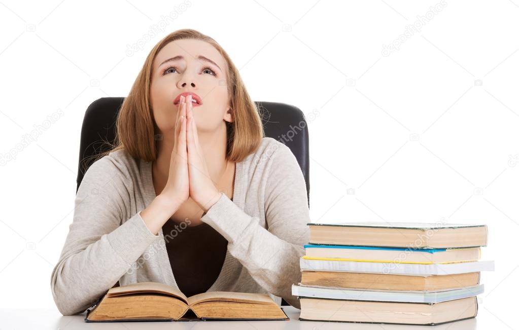 Woman praying to pass the exam