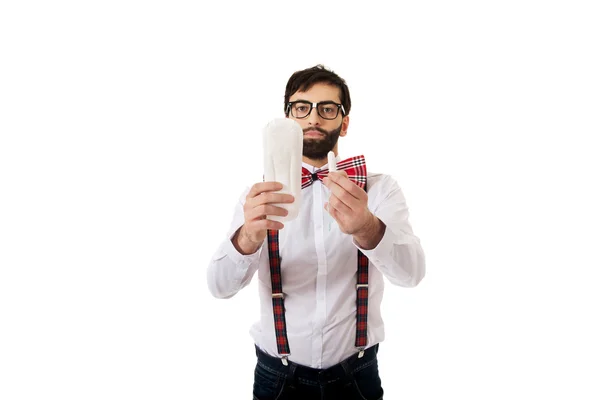 Man wearing suspenders holding menstruation pad. — Stock Photo, Image