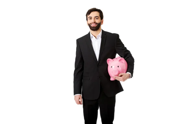 Biznesmen posiadający Piggy Bank. — Zdjęcie stockowe