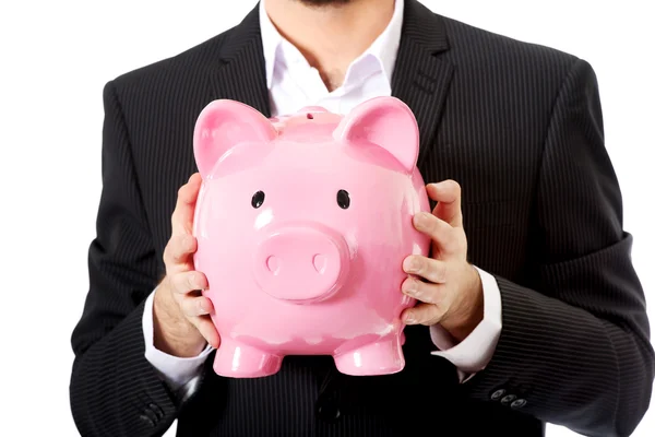 Businessman holding a piggy bank. — Stock Photo, Image