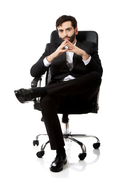 Young businessman sitting on a chair. — Stock Photo, Image