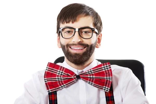 Young old fashioned man sitting by a desk. — Stock Photo, Image