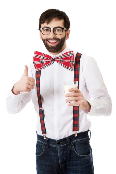 Man wearing suspenders with glass of milk. — Stock Photo, Image